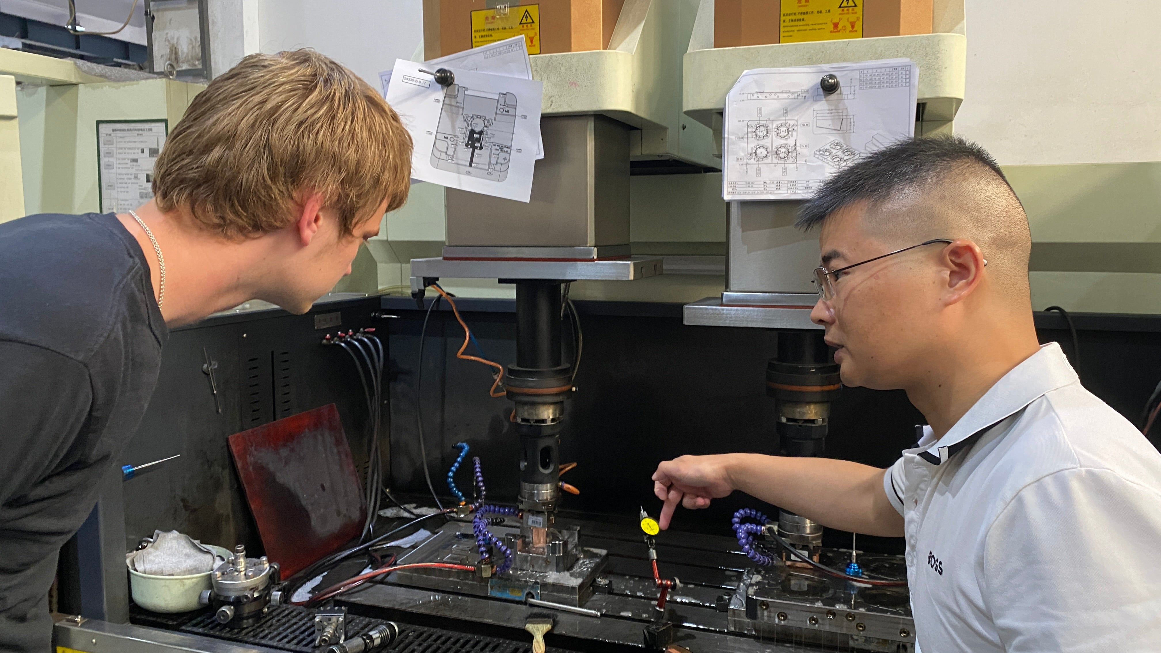 A Shenzhen hardware team discussing manufacturing equipment